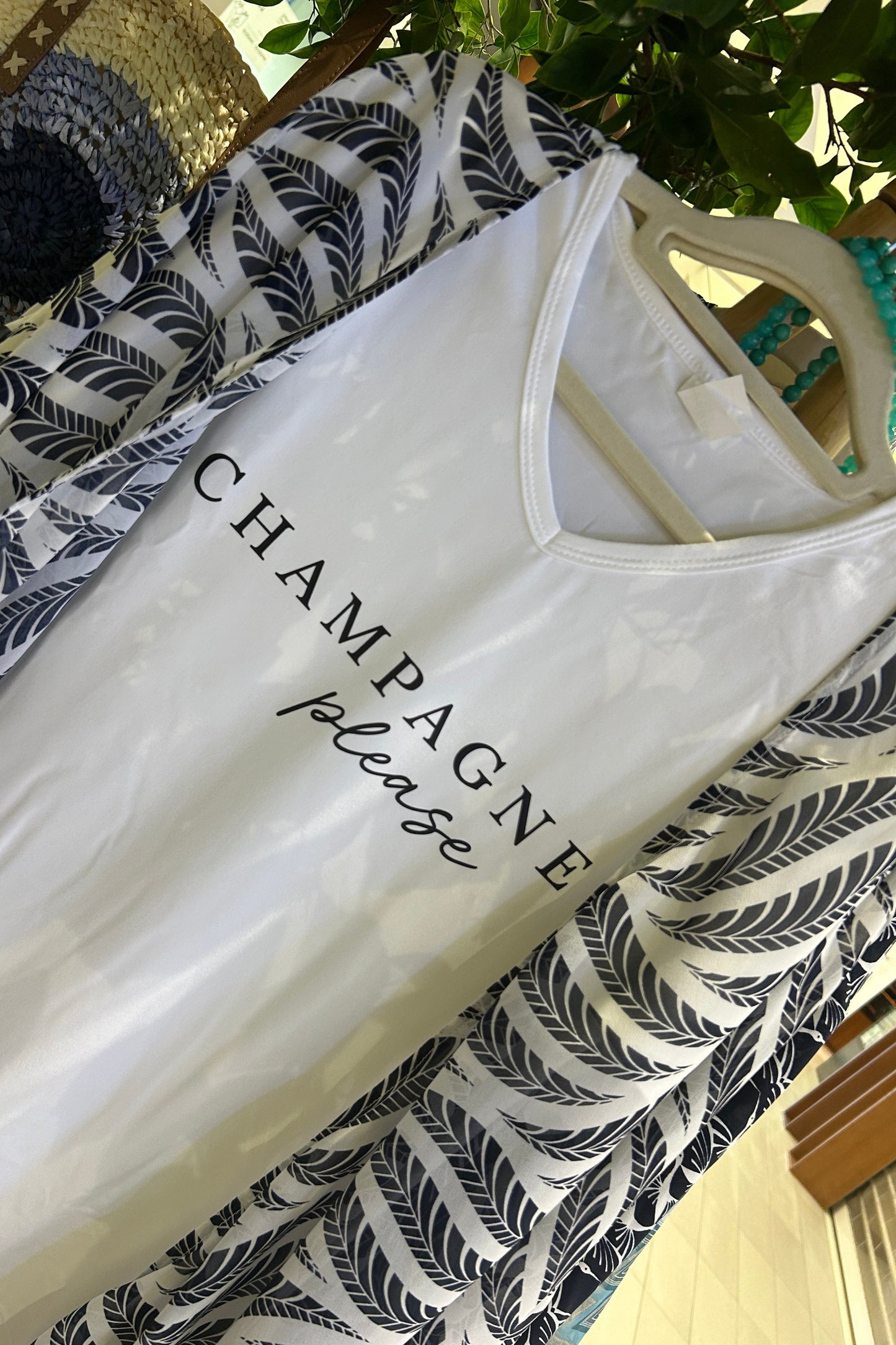 White V neck T shirt with 'Champagne Please' text worn with a navy and white chiffon kimono