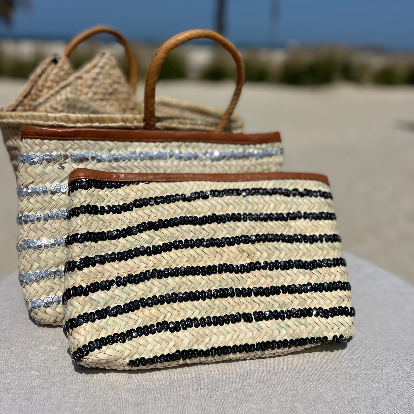 Morroccan handmade woven clutch bag with black sequin stripe and tan leather trim and zip to close