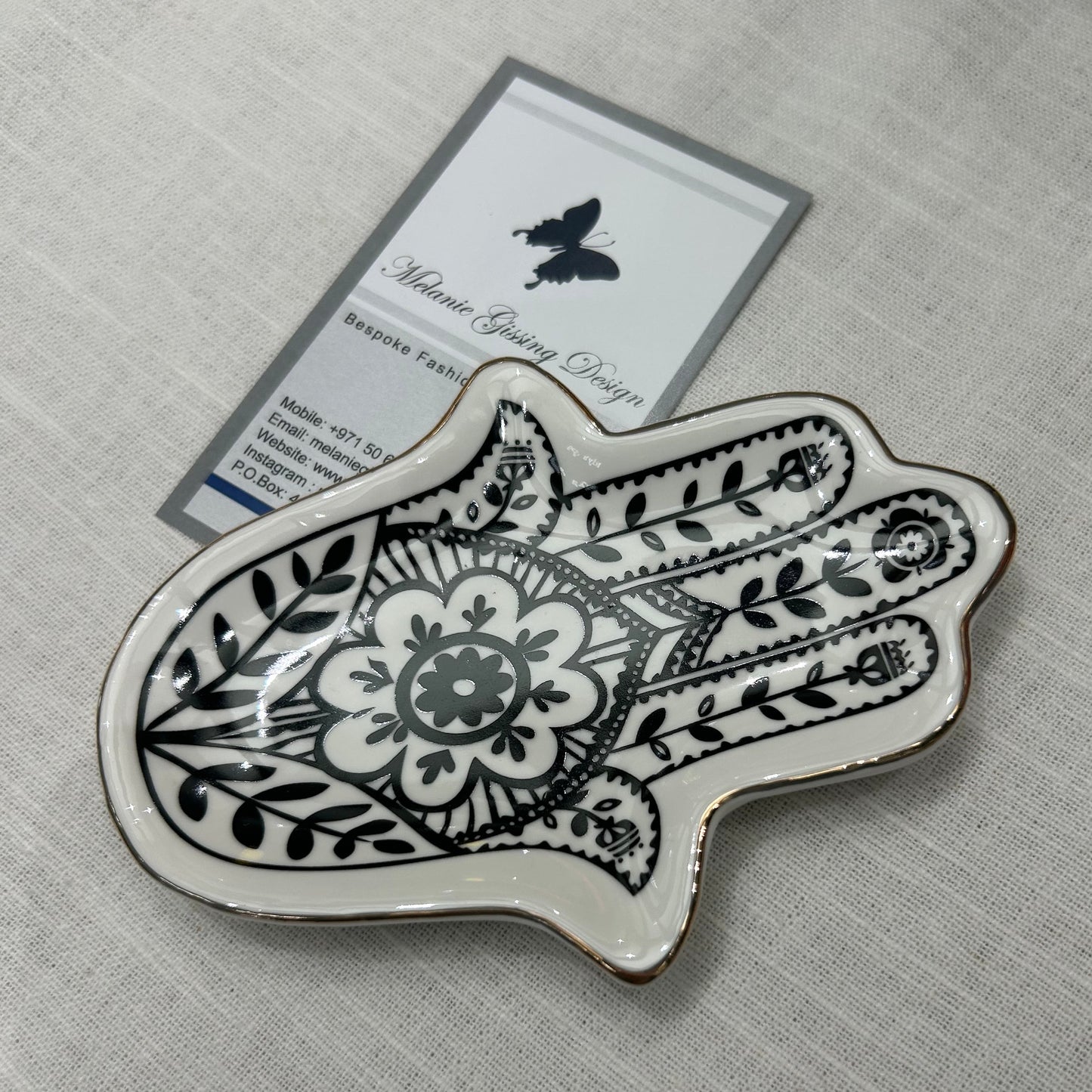 Hand of Fatima trinket dish in black and white with gold trim