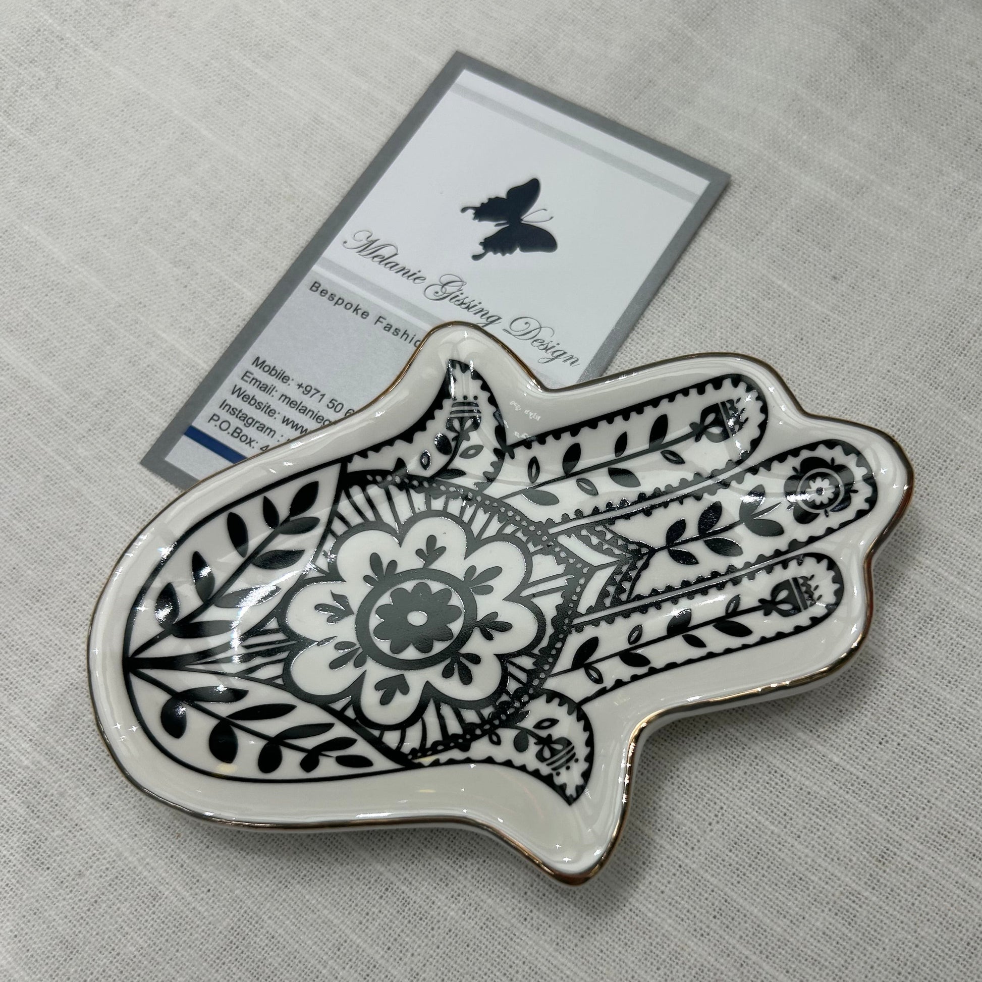 Hand of Fatima trinket dish in black and white with gold trim