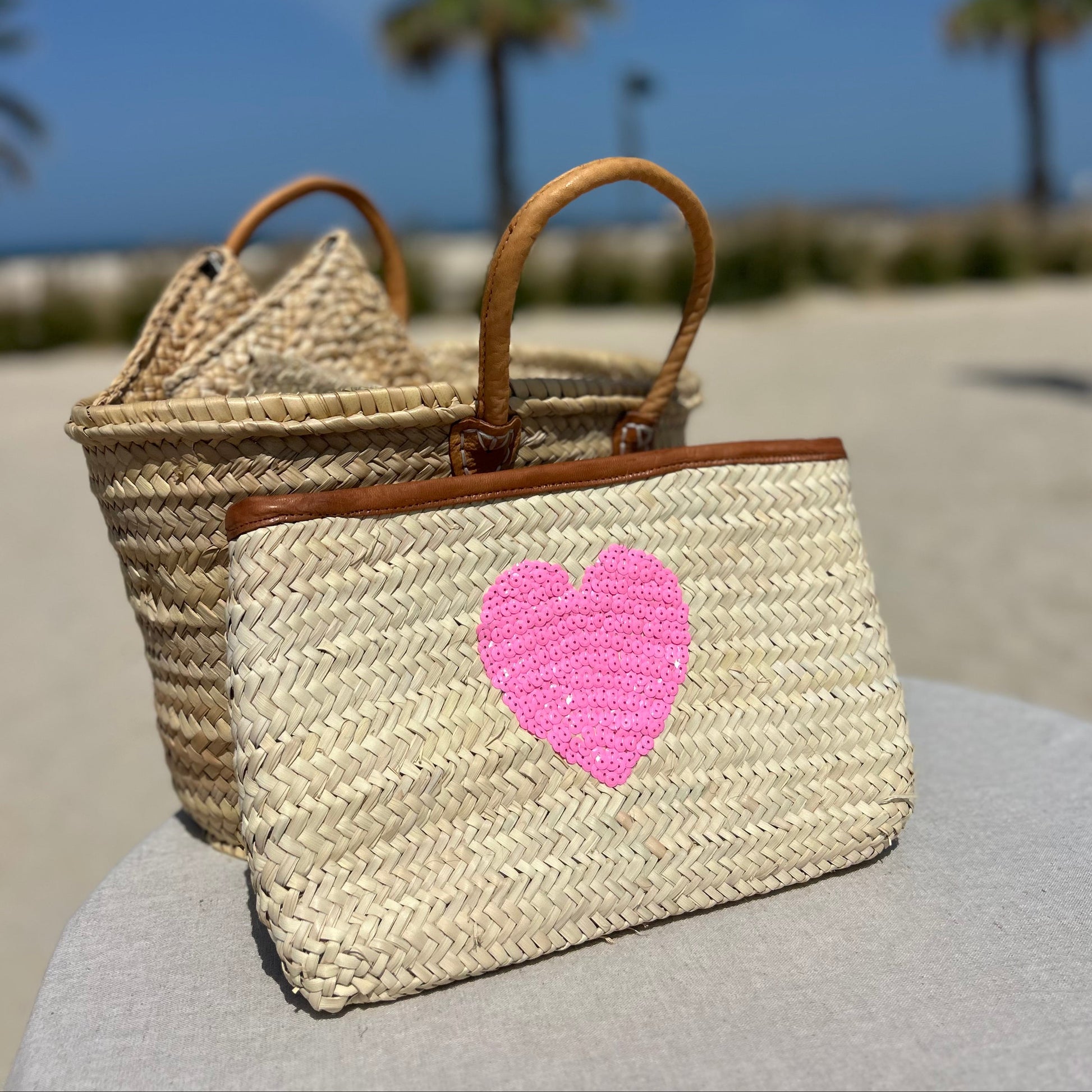 Natural palm Moroccan woven clutch bag with sequin pink heart and leather trim and zip fastener