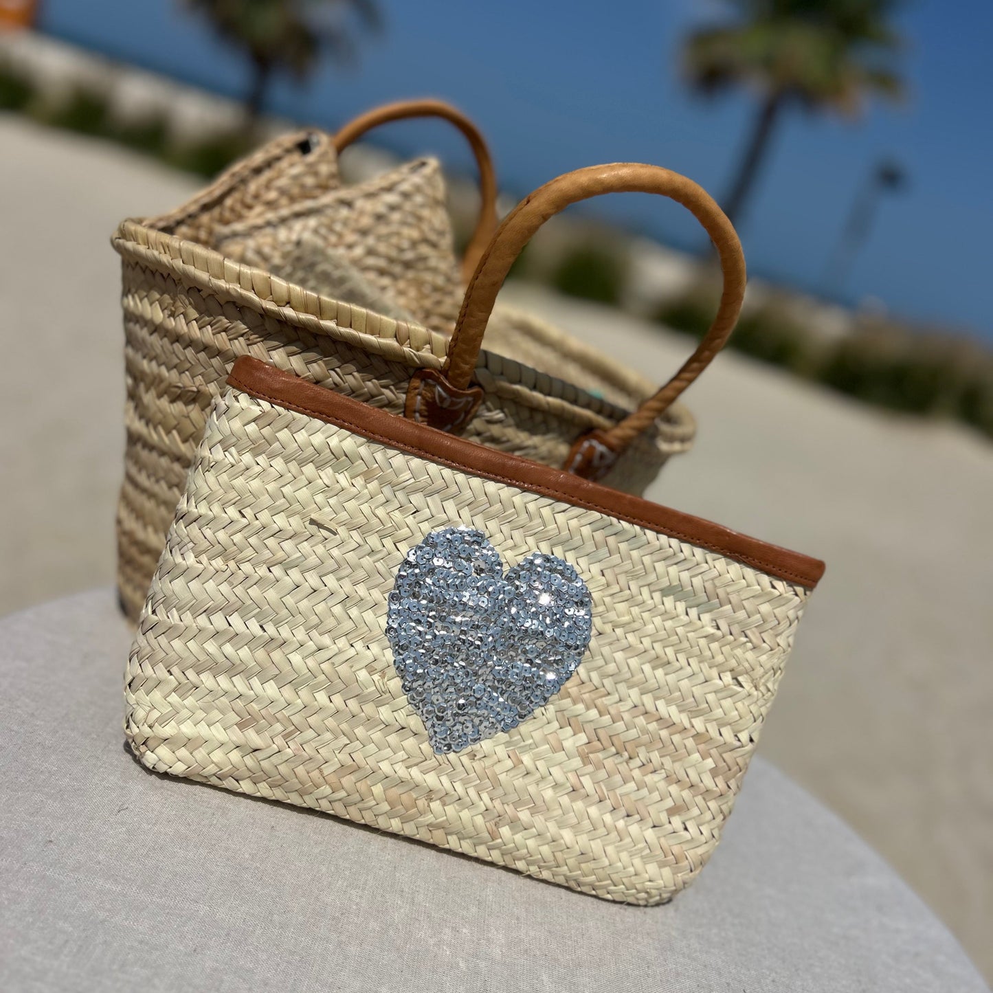 Natural palm Moroccan woven clutch bag with sequin silver heart and leather trim and zip fastener