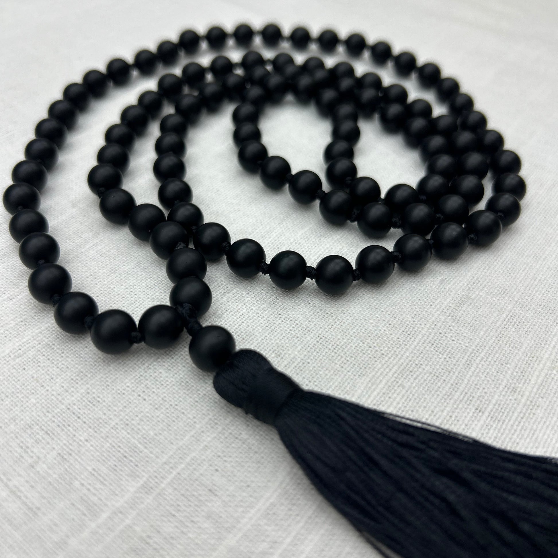 Black beaded necklace with a black tassel 