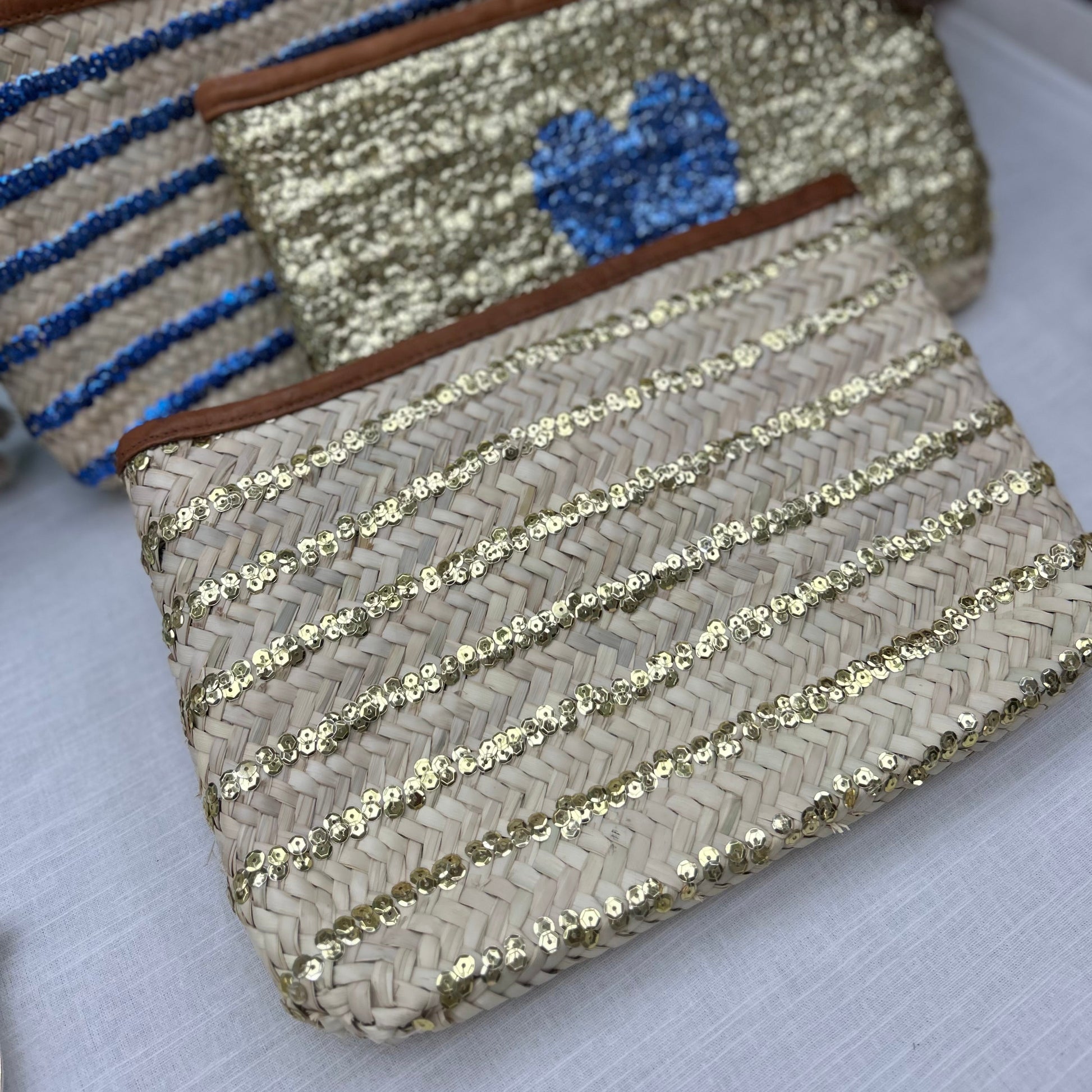 Morroccan hand made clutch bag with gold sequin stripe, tan leather trim and zip fastening
